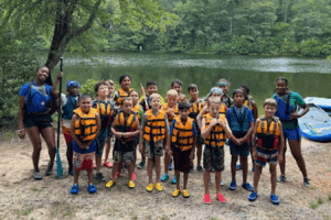 Aniyah beck with a group of children in life vests