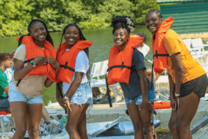 aniyah beck with a group of teens wearing life vests
